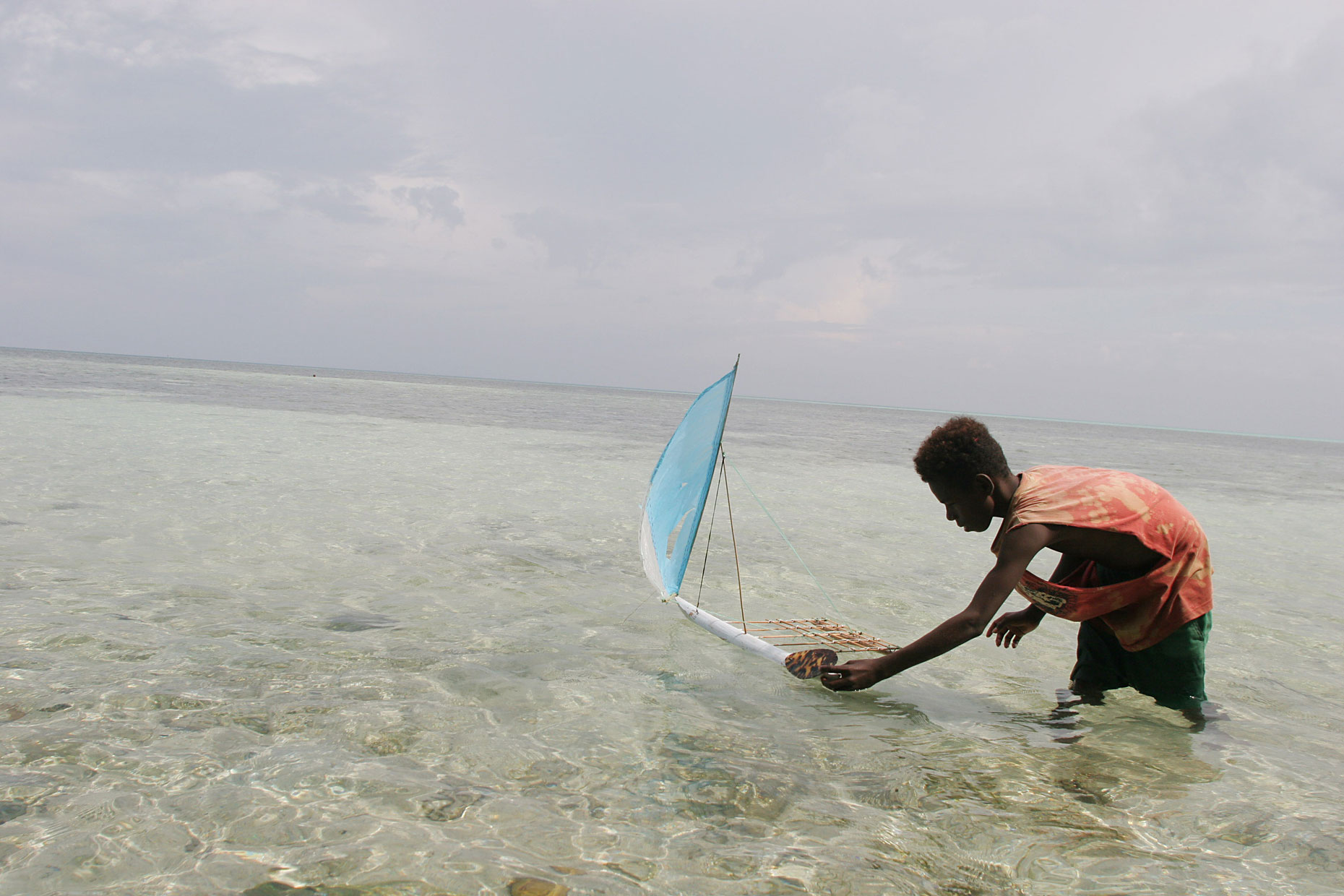 Toy boat in Pacific Atoll, by Scotland Greenpeace photographer