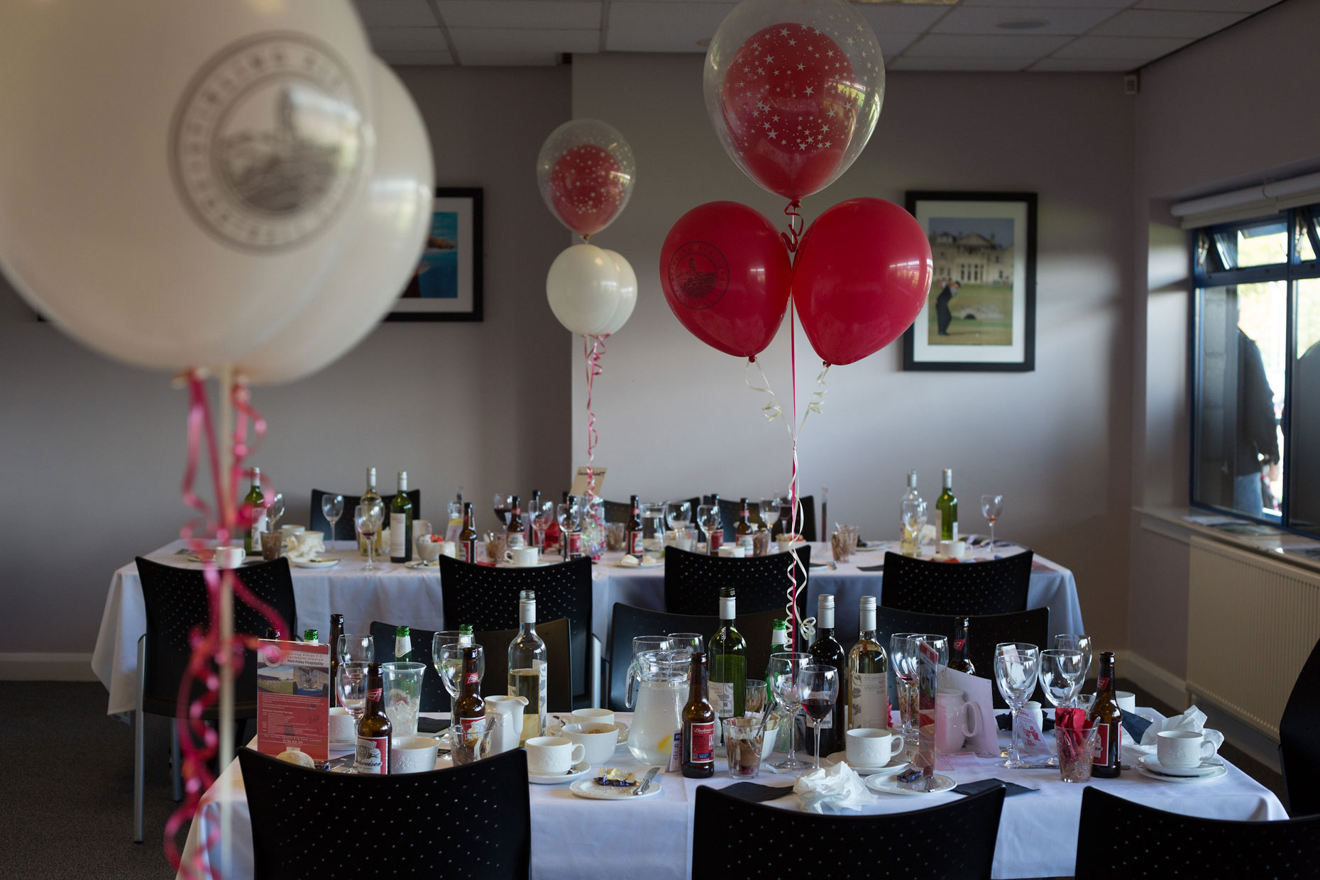 Ballons and dinner table at football club, Scotland, by photographer Sutton-Hibbert
