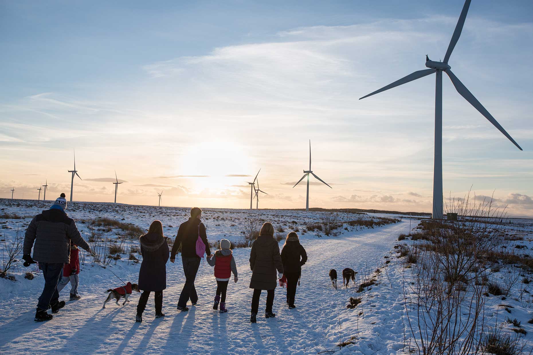 Family walking in snow at Whitelee wind farm, by Scotland Greenpeace photographer