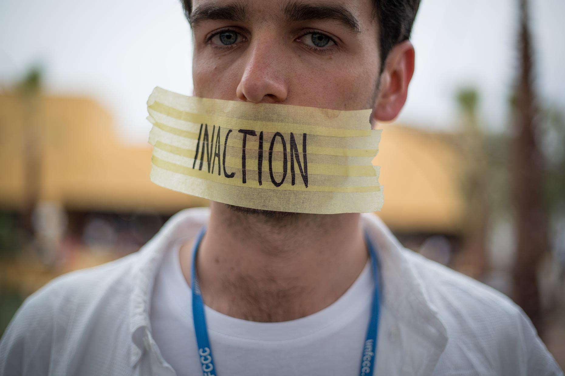 Inaction written on tape over mouth of activist, by Scotland Greenpeace photographer